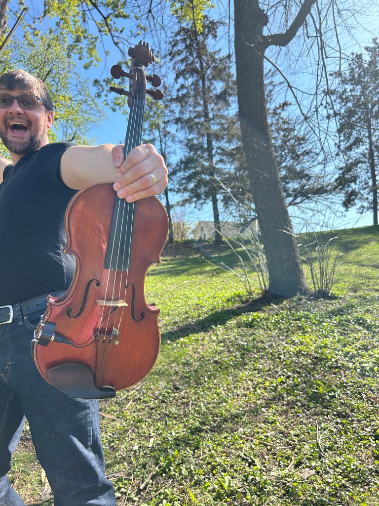 Excited viola player outside